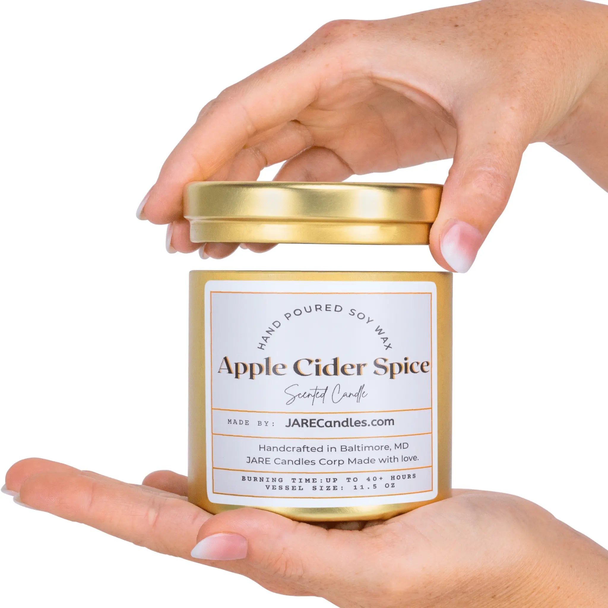 Hand holding Apple Cider Spice soy candle by JARE Candles, cinnamon clove nutmeg scented candle

