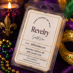 Revelry wax melts clamshell tilted on purple velvet beside a lit candle