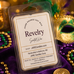Revelry wax melts clamshell on purple velvet with gold and green beads