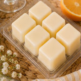 Six cream soy wax cubes in an open Sunday Brunch clamshell on a woven mat