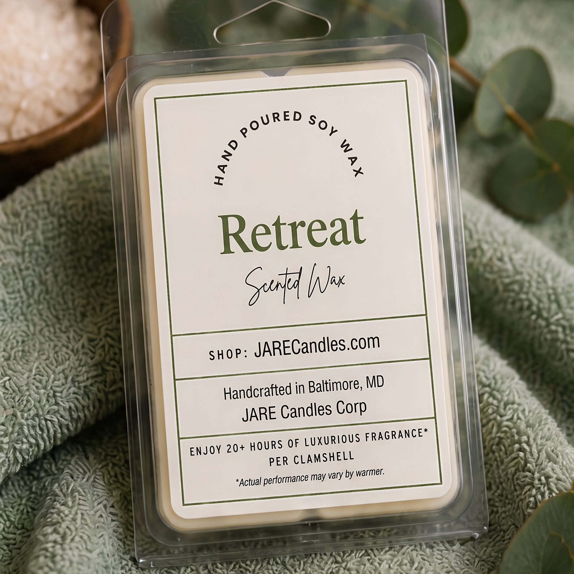 Retreat wax melts clamshell on a sage green spa towel with sea salt and eucalyptus