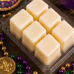 Six cream soy wax cubes in an open Revelry clamshell with Mardi Gras beads