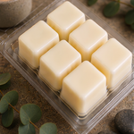 Six cream soy wax cubes in an open Retreat clamshell with eucalyptus sprigs