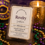 Revelry wax melts clamshell beside a glowing gold mercury glass candle