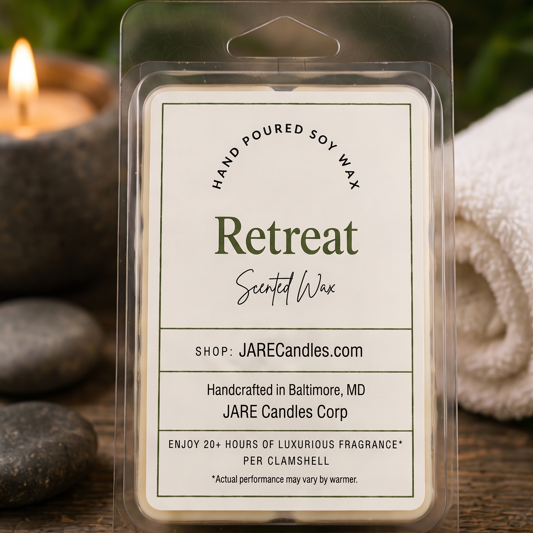 Retreat scented wax melts clamshell with river stones, spa towel and a lit candle