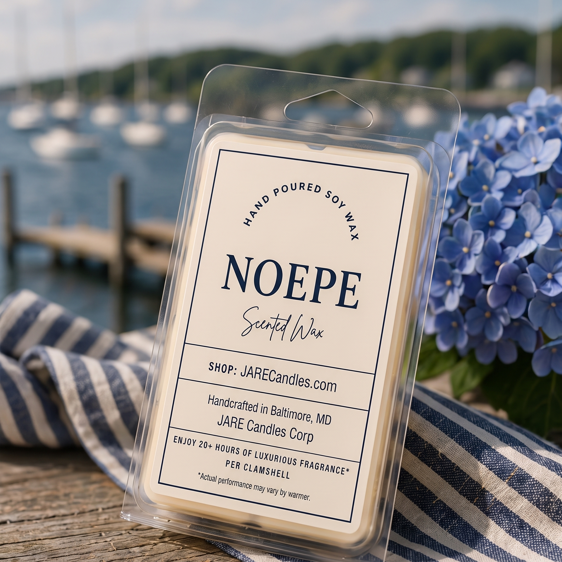 Noepe wax melts clamshell with a sailboat harbor and blue hydrangeas behind