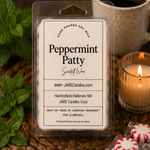 Peppermint Patty wax melts clamshell with mint sprigs and a lit ribbed glass candle