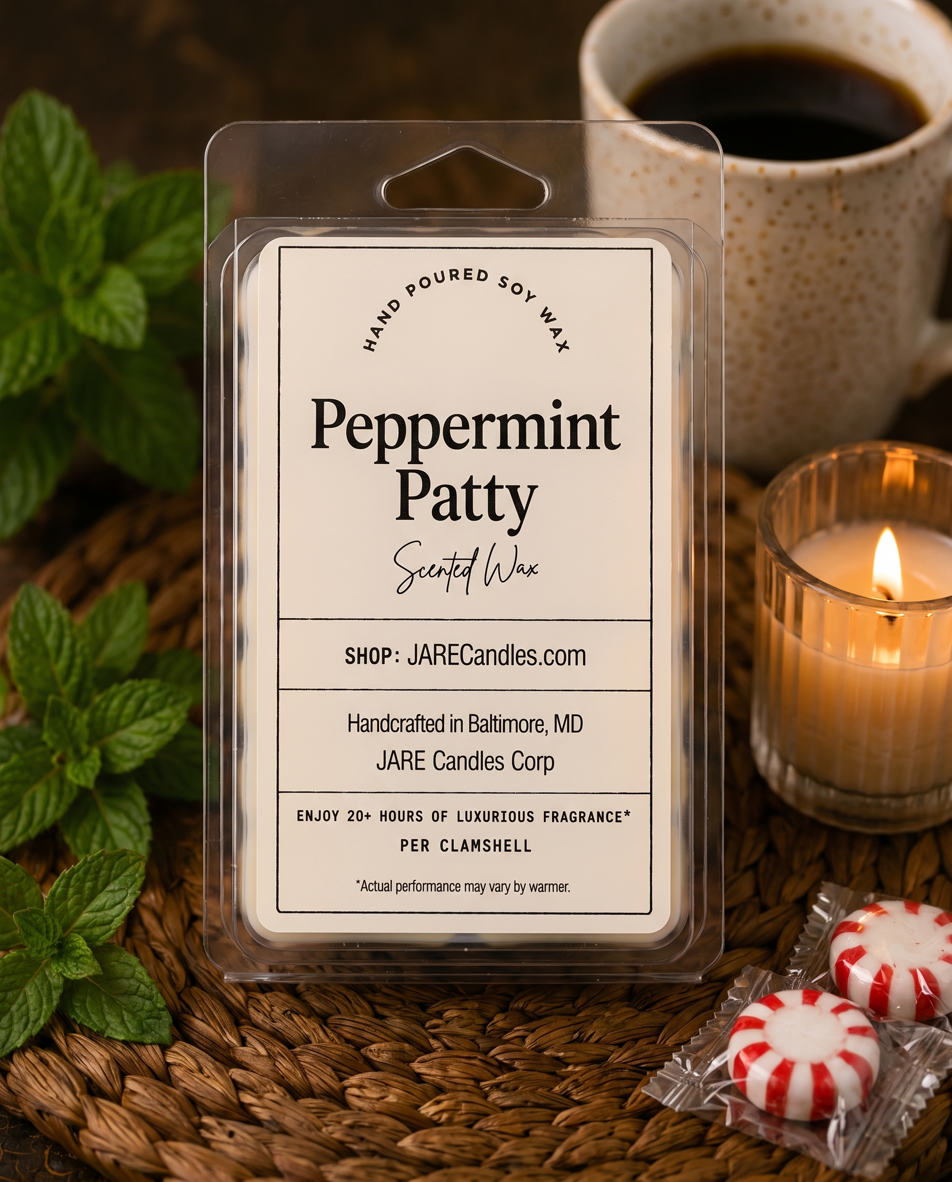 Peppermint Patty wax melts clamshell with mint sprigs and a lit ribbed glass candle