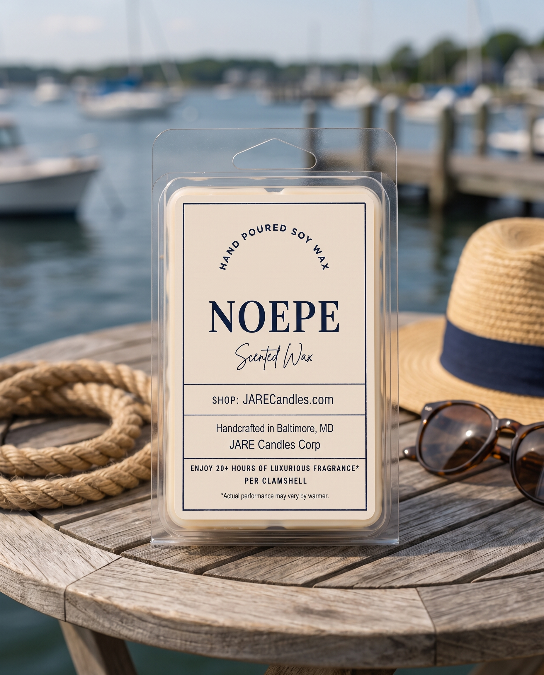 Noepe wax melts clamshell on a wooden table with a straw hat and sunglasses