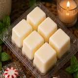Six cream soy wax cubes in an open Peppermint Patty clamshell with mint and candy