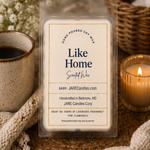 Like Home scented wax melts clamshell on a knit blanket with a mug and lit candle