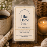Like Home scented wax melts clamshell on a knit blanket with a mug and lit candle