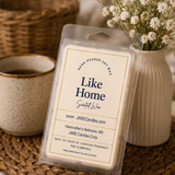 Like Home wax melts clamshell on a woven placemat with baby's breath and coffee