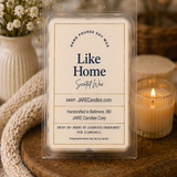 Like Home wax melts clamshell on a wooden board with dried flowers and candlelight