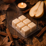 Six cream soy wax cubes in an open Drunken Pear clamshell with cinnamon, star anise and pear