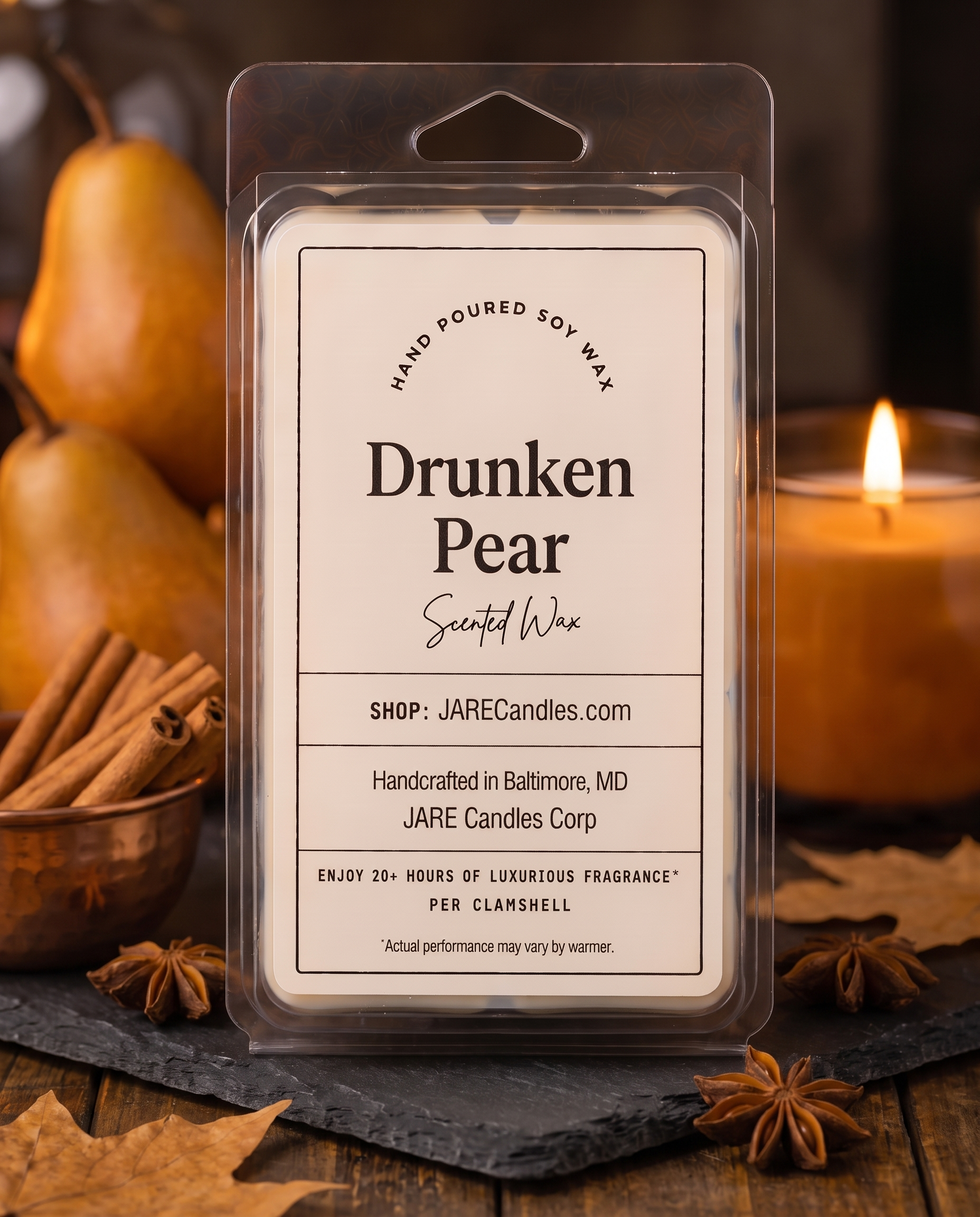 Drunken Pear wax melts clamshell on a slate board with pears, a copper bowl of cinnamon and a lit candle