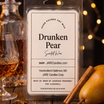 Drunken Pear wax melts clamshell beside a brandy decanter with warm string lights behind