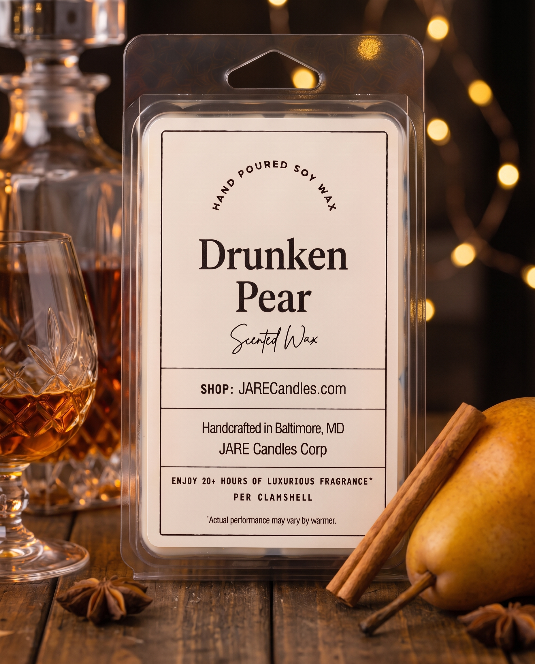 Drunken Pear wax melts clamshell beside a brandy decanter with warm string lights behind