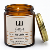 Lili 5oz amber jar candle, lit, lid resting against jar