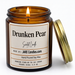 Drunken Pear 5oz amber jar candle, lit, lid resting against jar