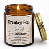 Drunken Pear 5oz amber jar candle, lit, lid resting against jar