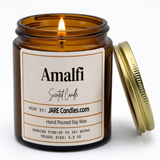 Amalfi 5oz amber jar candle, lit, lid resting against jar